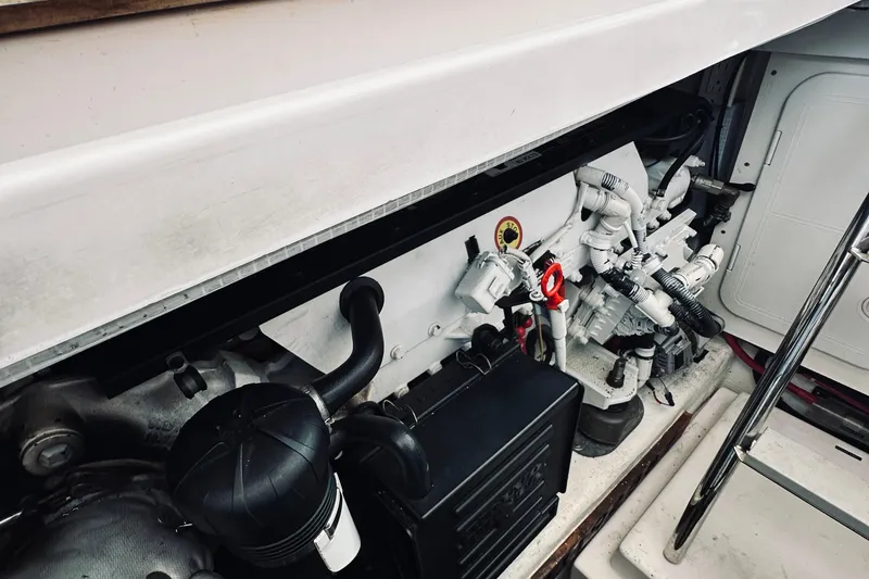 Slide: The Image of Engine compartment of 2007 Sabreline 34 Express boat, showcasing mechanical components and wiring. - 76