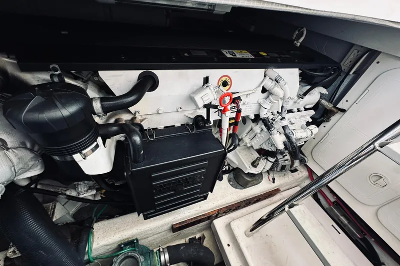 Slide: The Image of Engine compartment of a 2007 Sabreline 34 Express boat, showcasing detailed mechanical components. - 77