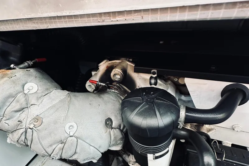 Slide: The Image of Engine compartment of a 2007 Sabreline 34 Express boat, showing insulated components and hoses. - 80