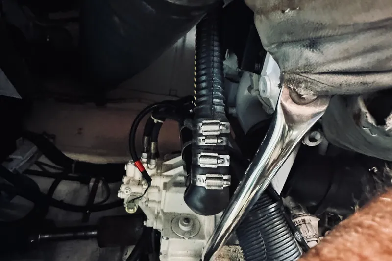 Slide: The Image of Engine compartment of a 2007 Sabreline 34 Express boat, showing hoses and mechanical components. - 81