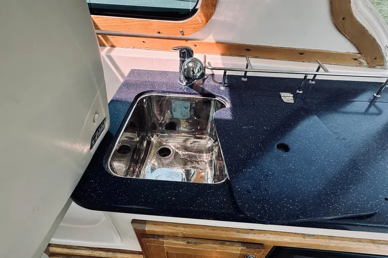 Slide: The Image of 2007 Sabreline 34 Express yacht kitchen sink with sleek countertop design. - 90