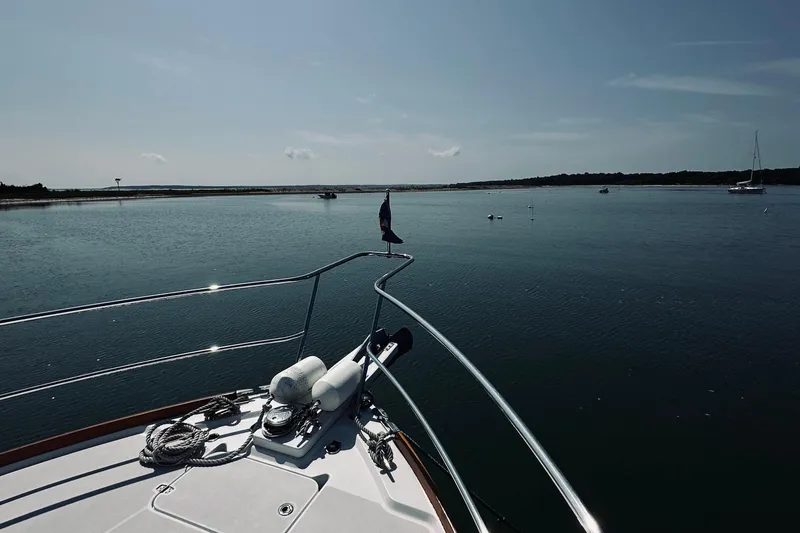 Slide: The Image of 2007 Sabreline 34 Express yacht on calm waters under a clear sky. - 98