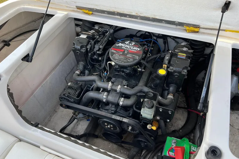 Slide: The Image of 2006 Tahoe Q4 boat engine compartment with Mercury 4.3 engine visible. - 11