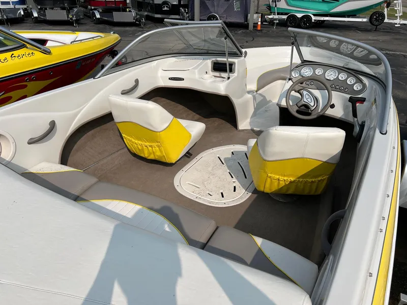 Slide: The Image of 2006 Tahoe Q4 boat interior with yellow and white seating, steering wheel, and dashboard. - 6