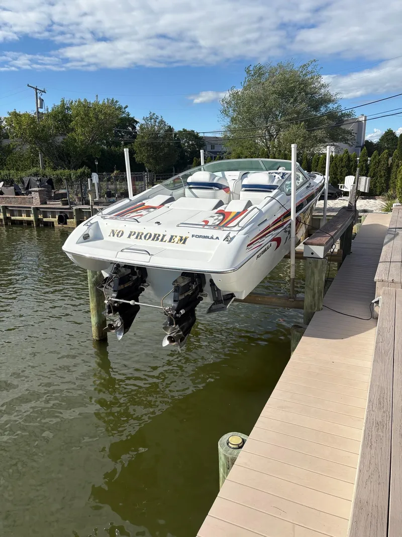 Slide: The Image of 2006 Formula 292 Fast Tech boat on lift, docked by waterfront. - 2