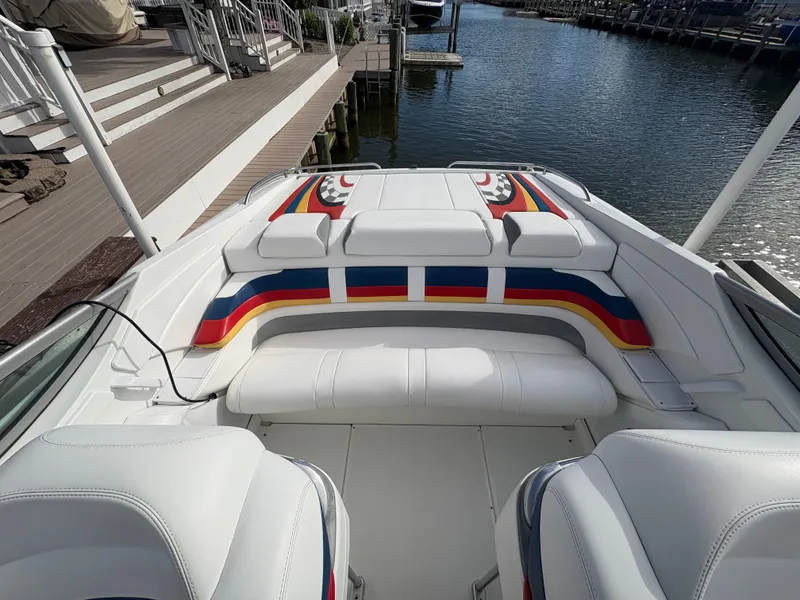 Slide: The Image of 2006 Formula 292 Fast Tech boat interior with colorful seating at a dock. - 5