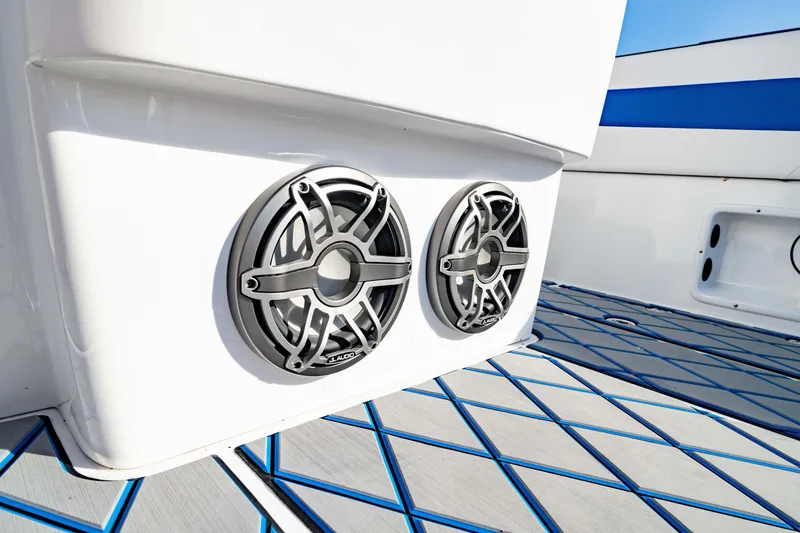 Slide: The Image of 2020 Sunsation 32 CCX speedboat cruising on open water, creating a dynamic wake. - 10