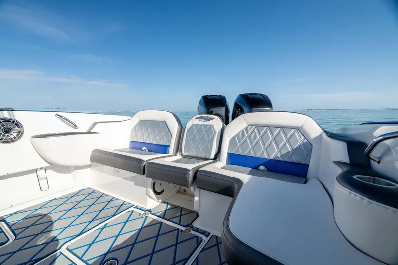 Slide: The Image of 2020 Sunsation 32 CCX boat speakers on a stylish blue and white deck. - 11