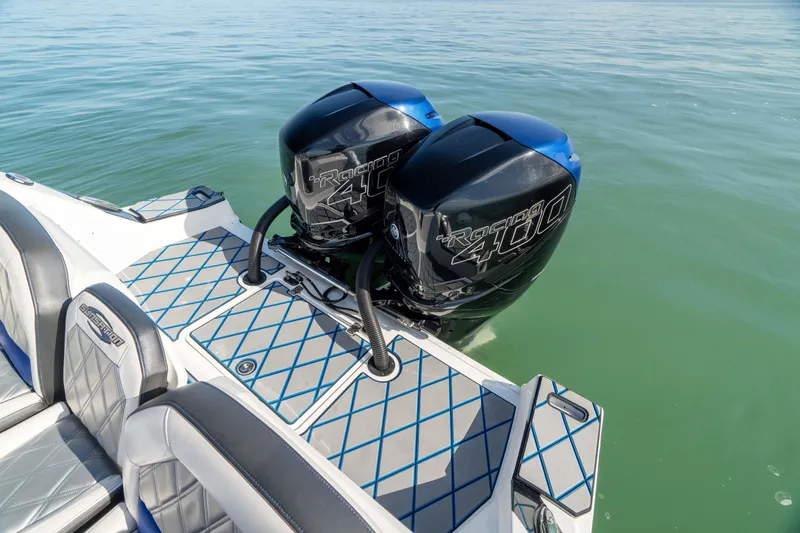 Slide: The Image of 2020 Sunsation 32 CCX boat cruising on open water, rear view. - 14