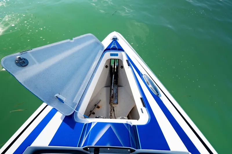 Slide: The Image of 2020 Sunsation 32 CCX boat interior with blue accents on calm water. - 16