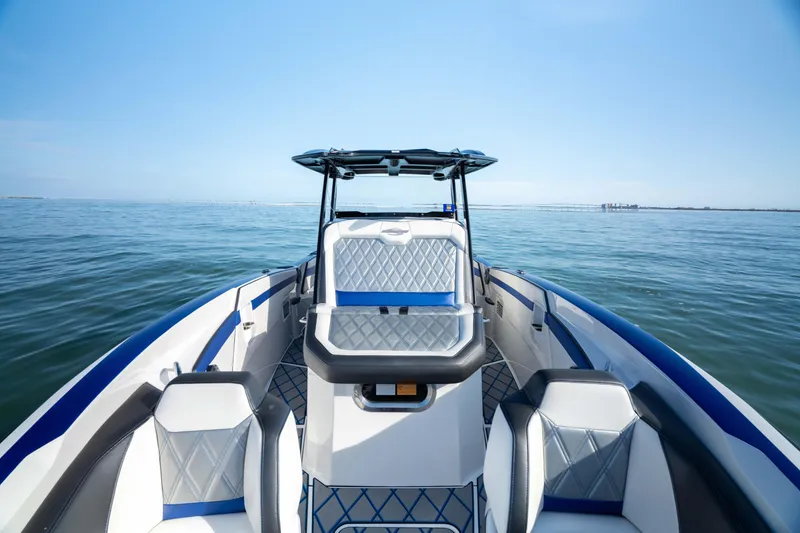 Slide: The Image of Open anchor compartment on 2020 Sunsation 32 CCX boat, floating on clear green water. - 17