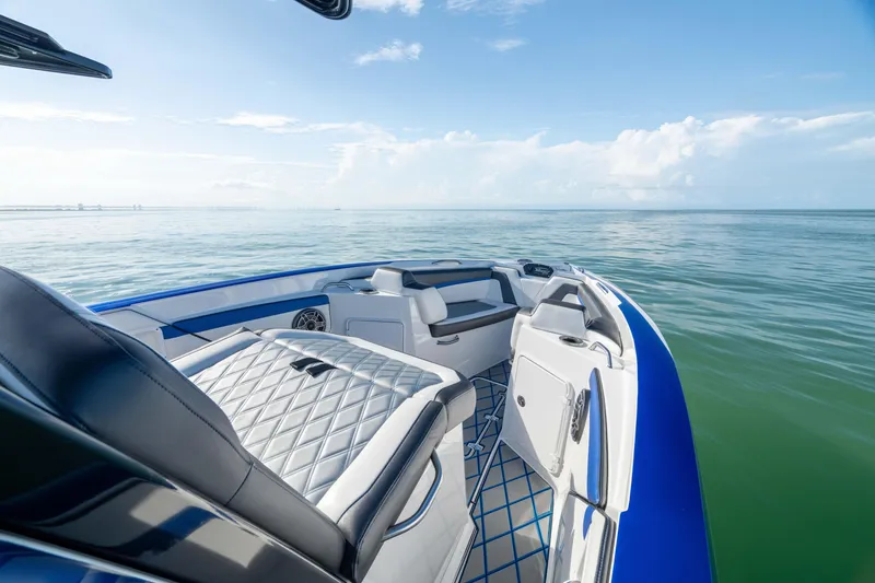 Slide: The Image of Interior cabin of 2020 Sunsation 32 CCX boat, featuring white seating and open door. - 2