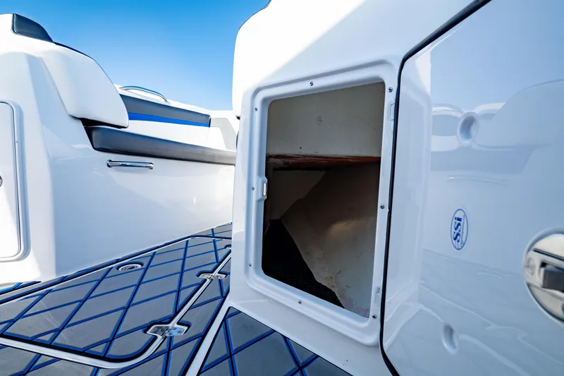 Slide: The Image of 2020 Sunsation 32 CCX boat interior storage compartment with sleek design and blue accents. - 26