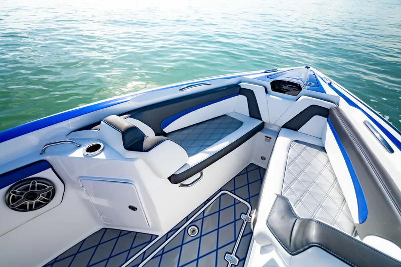 Slide: The Image of 2020 Sunsation 32 CCX boat interior with blue and white seating, on calm water. - 27
