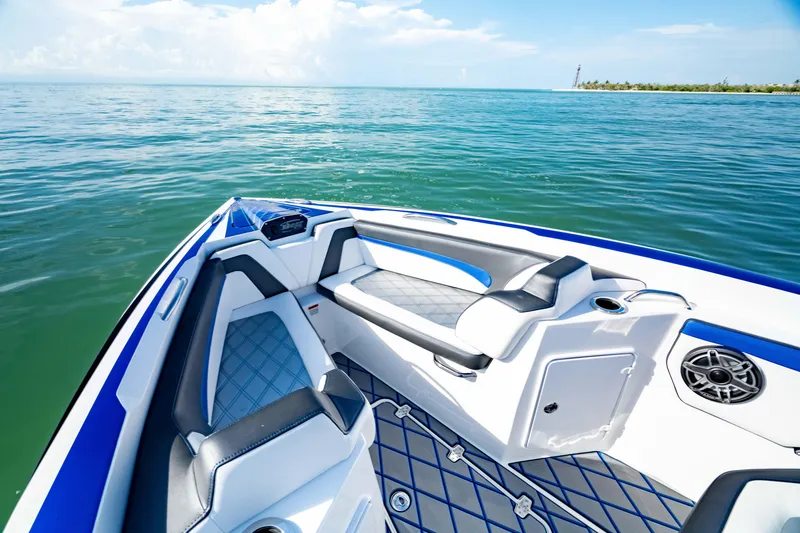 Slide: The Image of 2020 Sunsation 32 CCX boat interior with blue and white seating on open water. - 28