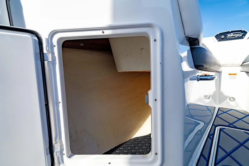 Slide: The Image of 2020 Sunsation 32 CCX boat storage compartment with open hatch, showcasing interior space. - 29