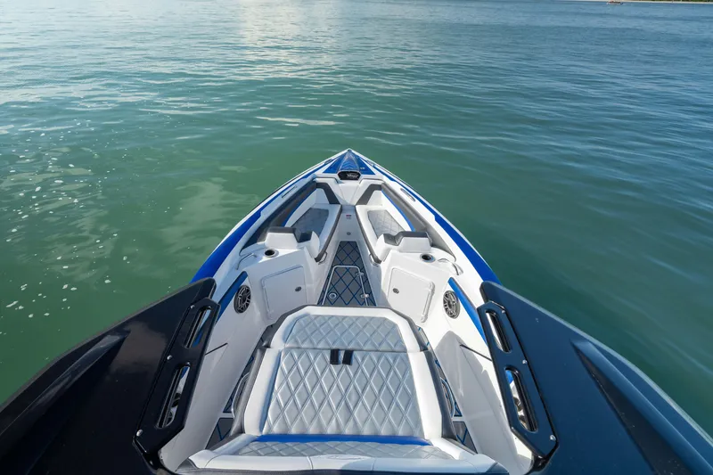 Slide: The Image of 2020 Sunsation 32 CCX boat bow on calm water, featuring sleek design and seating. - 31