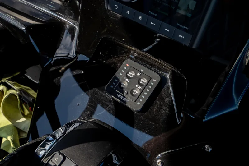 Slide: The Image of Control panel of 2020 Sunsation 32 CCX boat, featuring navigation and trim controls. - 32