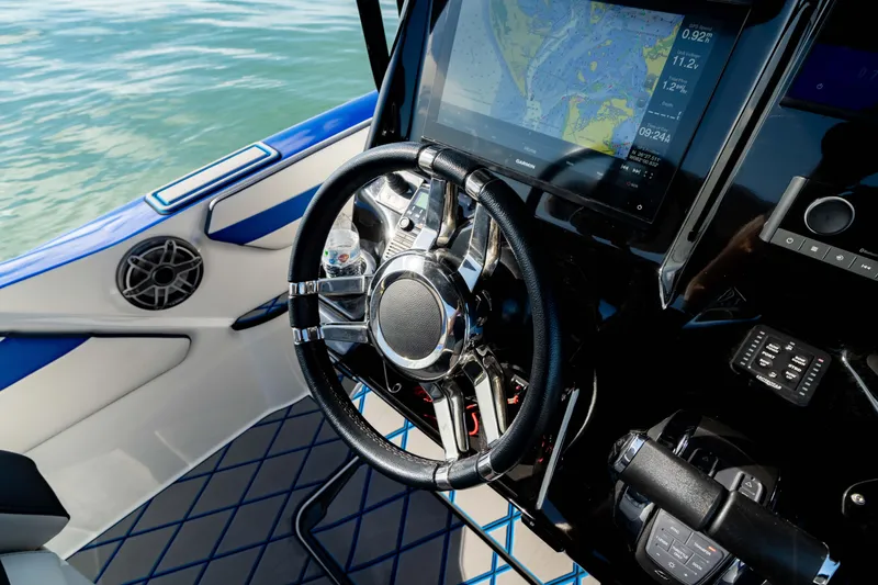 Slide: The Image of 2020 Sunsation 32 CCX boat dashboard with steering wheel and navigation display. - 35