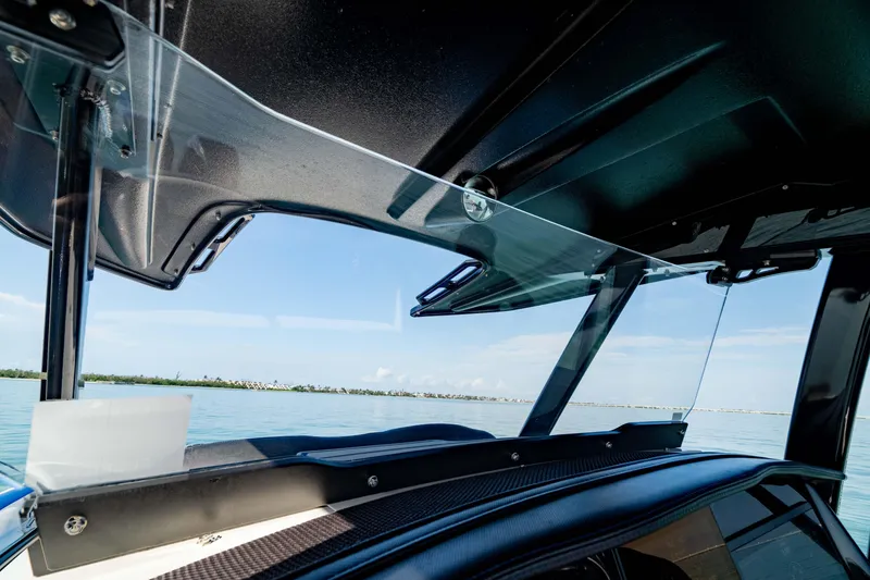 Slide: The Image of 2020 Sunsation 32 CCX boat windshield with ocean view in the background. - 36