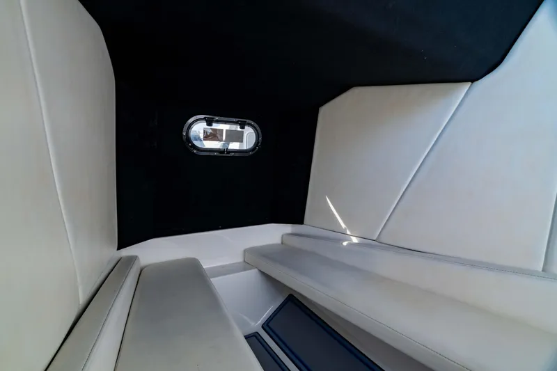 Slide: The Image of Interior cabin of 2020 Sunsation 32 CCX boat with cushioned seating and porthole window. - 37