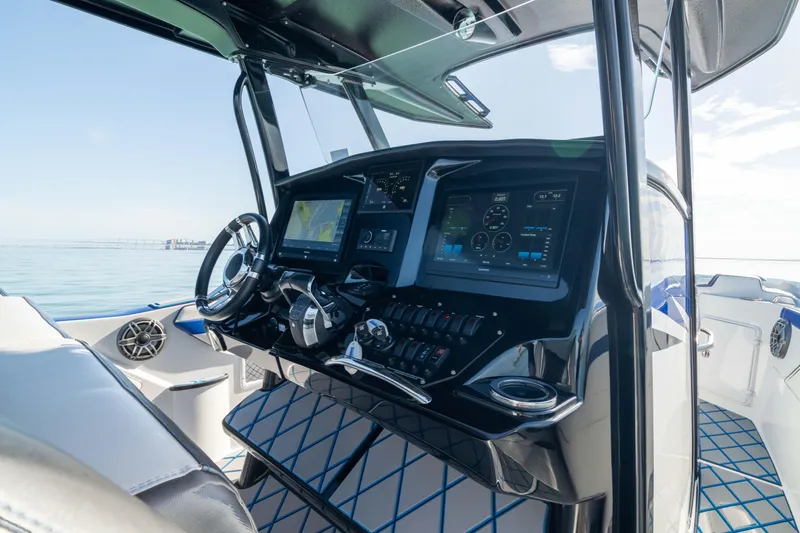 Slide: The Image of 2020 Sunsation 32 CCX boat interior with luxurious seating on calm ocean waters. - 4