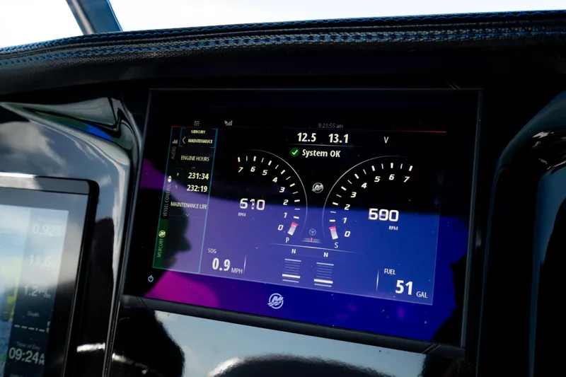 Slide: The Image of 2020 Sunsation 32 CCX boat interior with blue and white seating on calm water. - 5