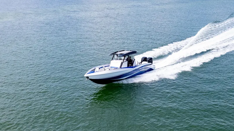 Slide: The Image of 2020 Sunsation 32 CCX boat cockpit with modern navigation displays and steering wheel. - 9