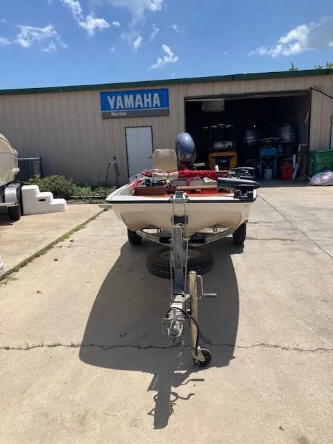 Slide: The Image of 1980 Boston Whaler 13 boat on trailer outside Yamaha marine shop. - 6