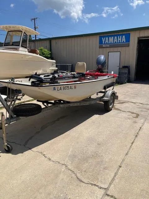 Slide: The Image of 1980 Boston Whaler 13 boat on trailer outside Yamaha Marine shop. - 7