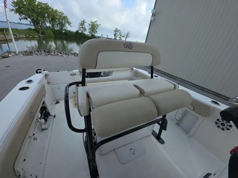 Slide: The Image of 2018 NauticStar 22 XS Offshore boat interior with seating and water view. - 10