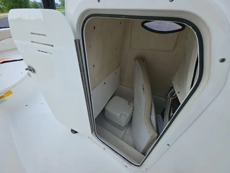Slide: The Image of 2018 NauticStar 22 XS Offshore boat storage compartment with open door. - 11