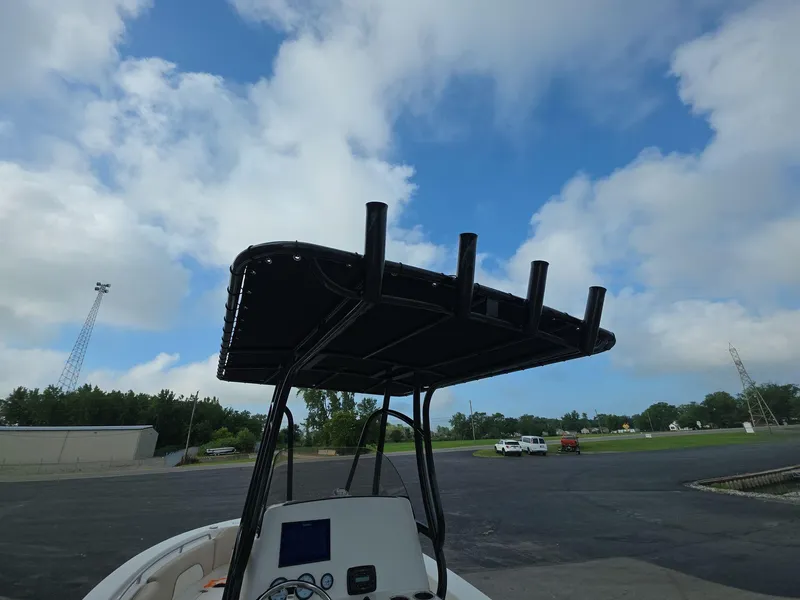 Slide: The Image of 2018 NauticStar 22 XS Offshore boat with T-top against a cloudy sky. - 12