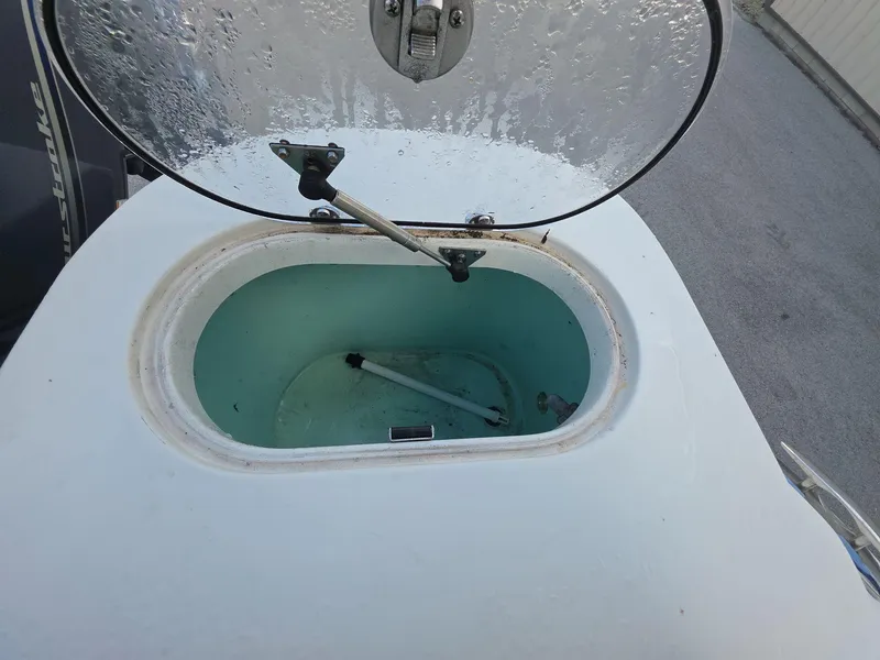 Slide: The Image of Open hatch on 2018 NauticStar 22 XS Offshore boat, showing interior compartment. - 15