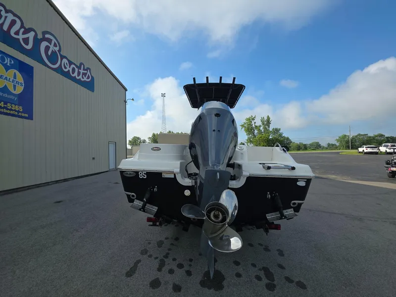 Slide: The Image of 2018 NauticStar 22 XS Offshore boat with outboard motor, parked outside a dealership. - 4