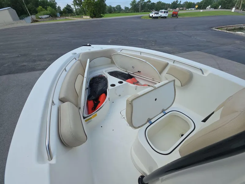 Slide: The Image of 2018 NauticStar 22 XS Offshore boat interior with open storage compartments and seating. - 6