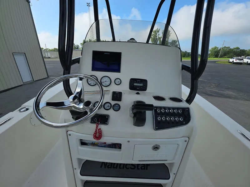 Slide: The Image of 2018 NauticStar 22 XS Offshore boat console with steering wheel and controls. - 7