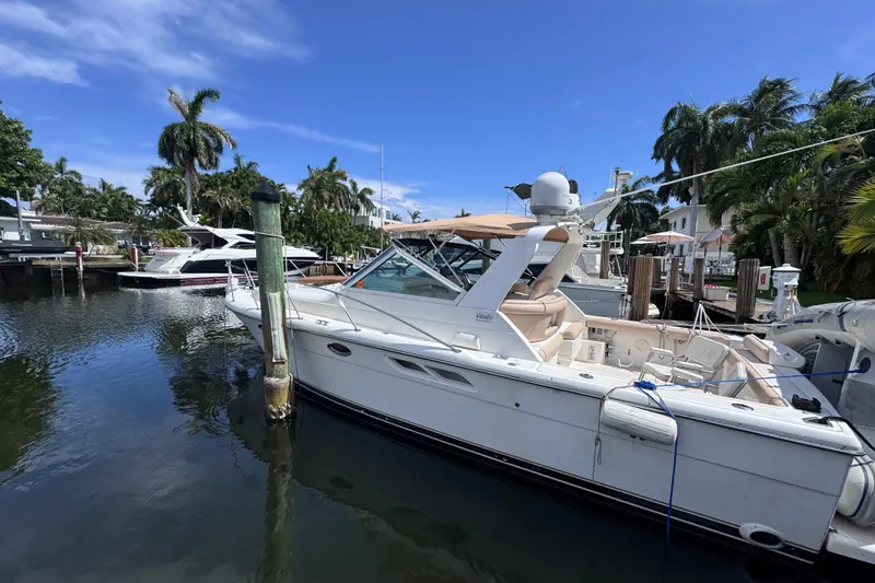 Slide: The Image of 2001 Tiara Yachts 3100 Open docked in a tropical marina setting. - 10