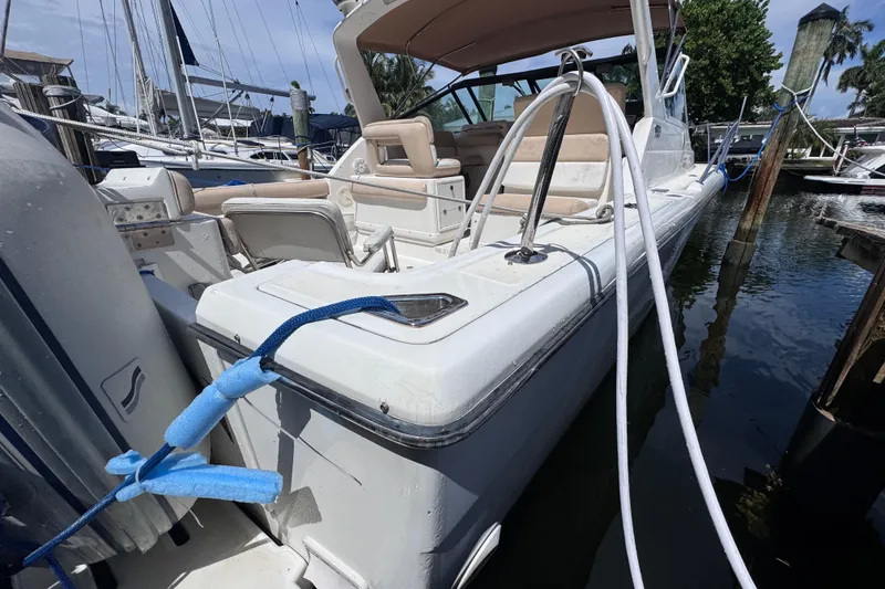 Slide: The Image of 2001 Tiara Yachts 3100 Open docked, featuring sleek design and comfortable seating. - 11