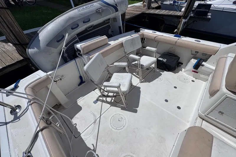 Slide: The Image of 2001 Tiara Yachts 3100 Open boat deck with seating and inflatable dinghy. - 12