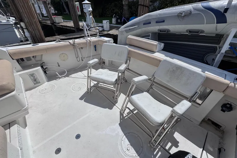 Slide: The Image of 2001 Tiara Yachts 3100 Open deck with chairs and inflatable boat. - 13
