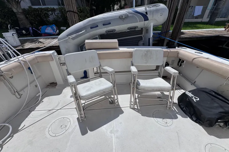 Slide: The Image of 2001 Tiara Yachts 3100 Open deck with two chairs and inflatable boat. - 14