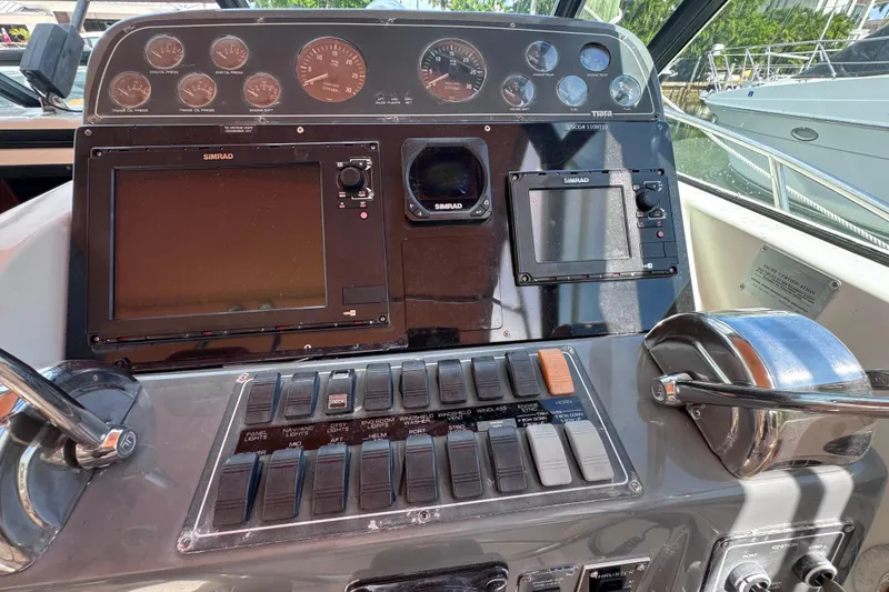 Slide: The Image of Dashboard of a 2001 Tiara Yachts 3100 Open with navigation controls and gauges. - 15