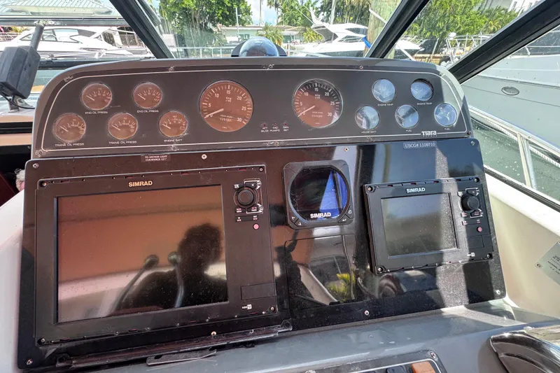 Slide: The Image of Control panel of a 2001 Tiara Yachts 3100 Open with Simrad navigation equipment. - 16