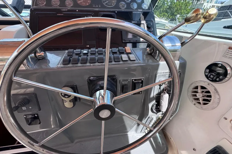 Slide: The Image of Helm of 2001 Tiara Yachts 3100 Open, featuring steering wheel and control panel. - 17