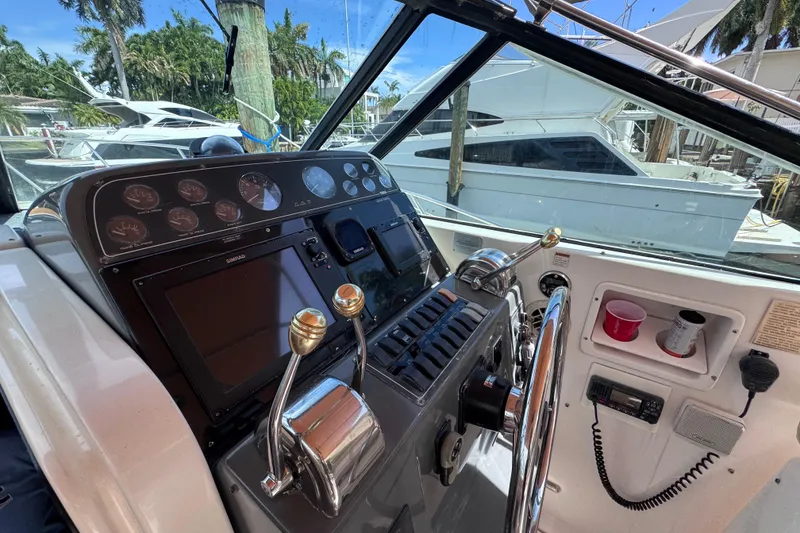 Slide: The Image of 2001 Tiara Yachts 3100 Open helm with controls and navigation equipment. - 19