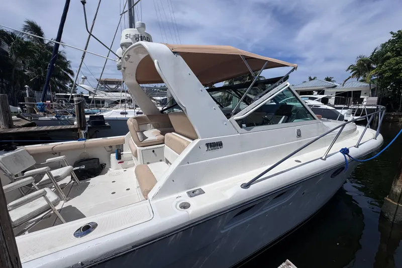 Slide: The Image of 2001 Tiara Yachts 3100 Open docked, featuring spacious seating and sleek design. - 2