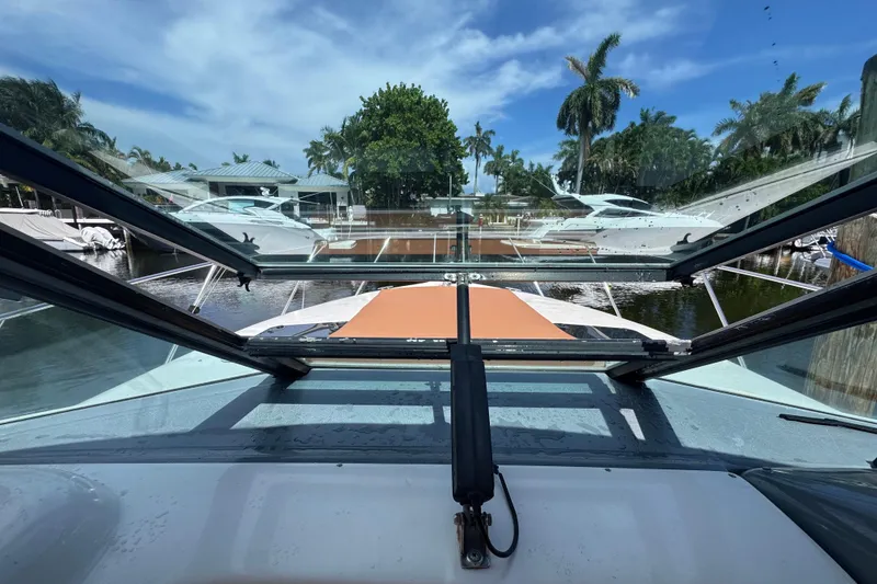 Slide: The Image of 2001 Tiara Yachts 3100 Open, view from cockpit, marina backdrop, palm trees, blue sky. - 20
