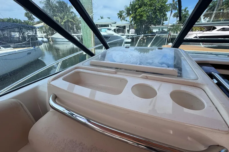 Slide: The Image of 2001 Tiara Yachts 3100 Open interior with cup holders and marina view. - 23