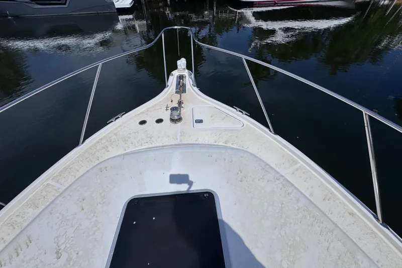Slide: The Image of Bow view of 2001 Tiara Yachts 3100 Open, docked on calm water. - 25